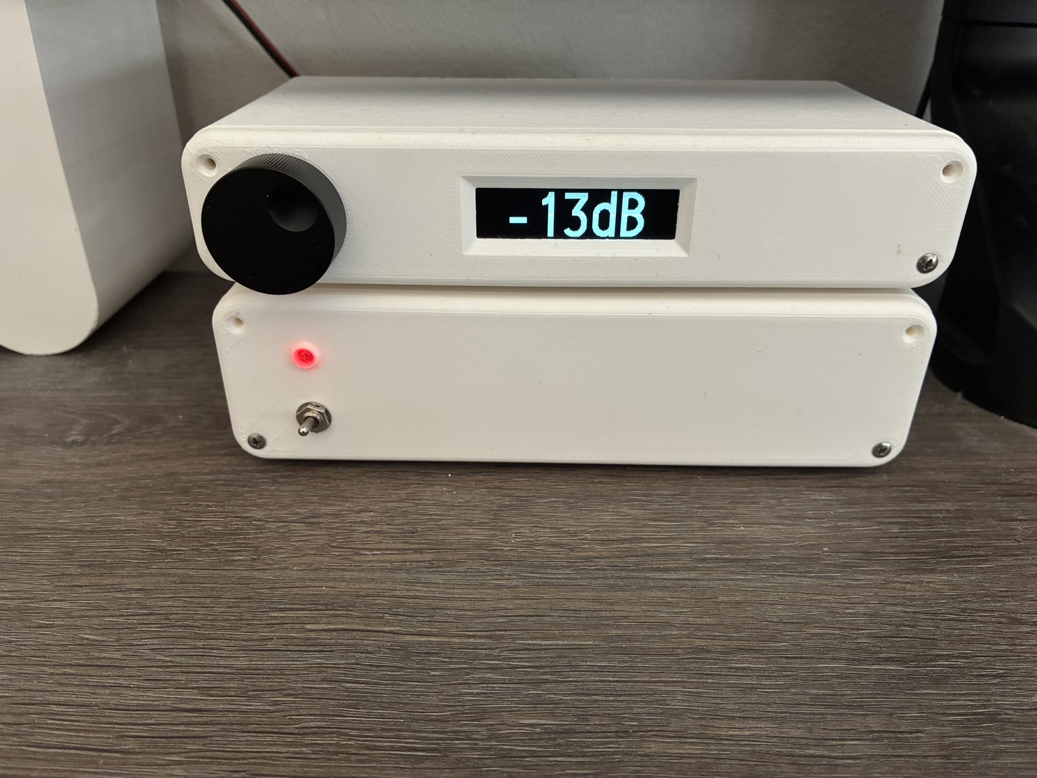 Photograph of 2 white enclosures housing the DSP/DAC (top) and Amplifier (bottom)